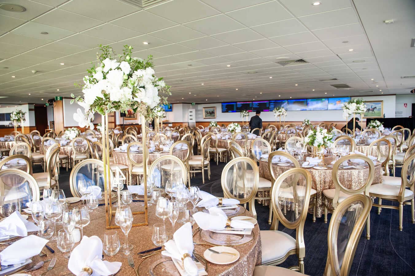 Empty lavishly decorated tables in a function room at a racecourse