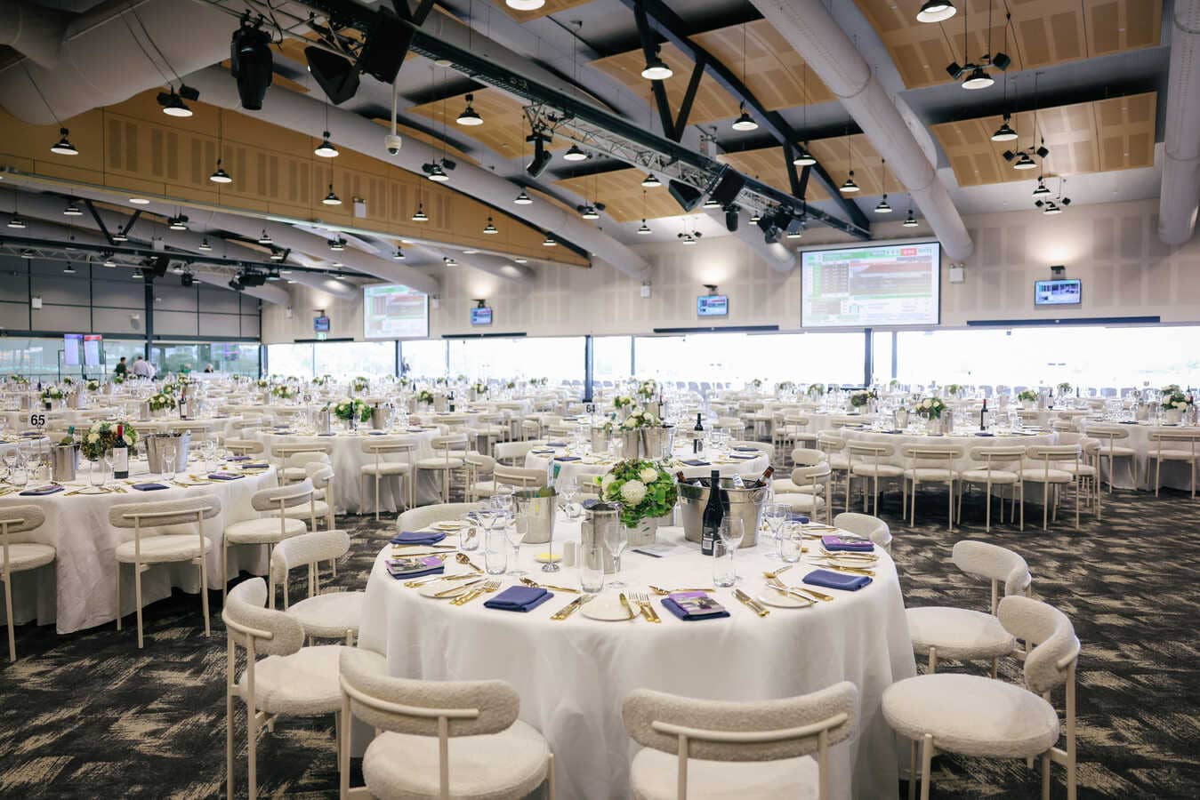 An empty function room filled with lavishly decorated tables