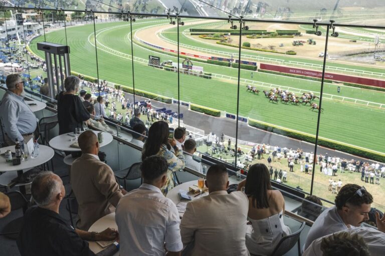 Patrons are shown watching a horse race from the Panoramas dining venue at Royal Randwick.