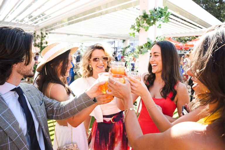 A group of racegoers raise their glasses at Royal Randwick racecourse.
