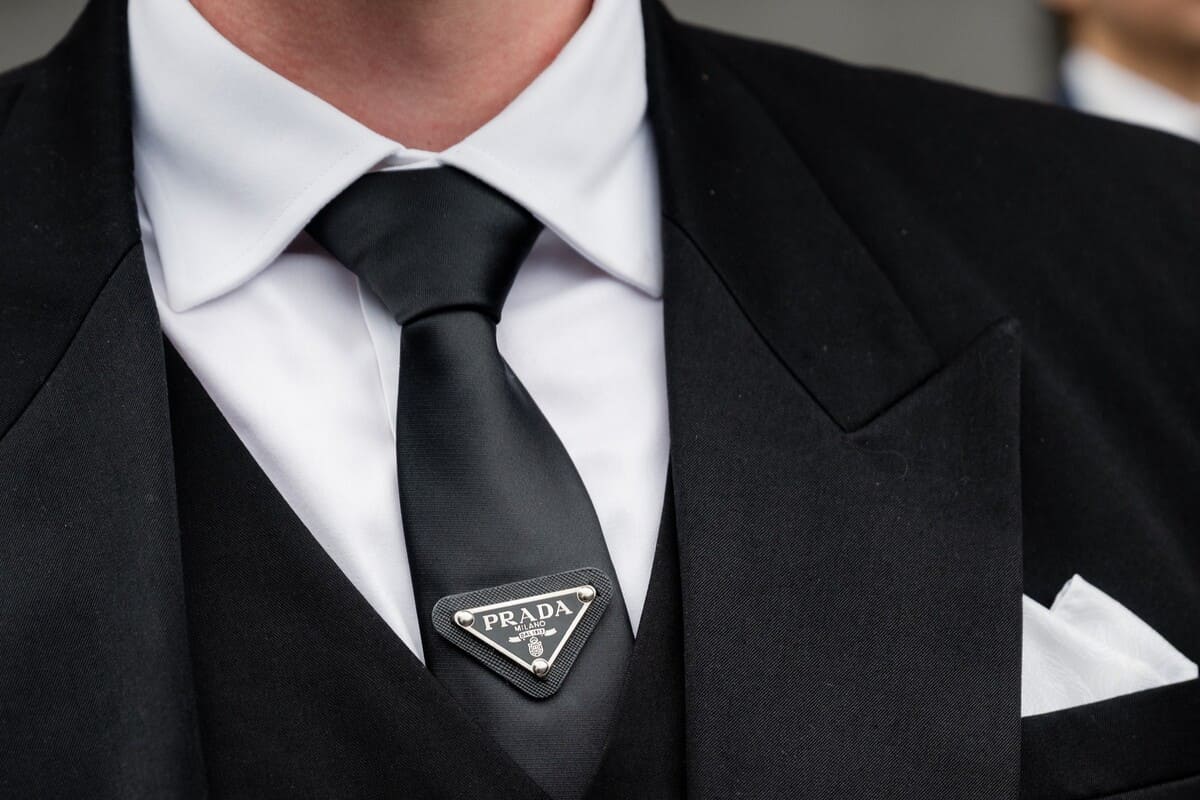 Close up of a man wearing a black suit.